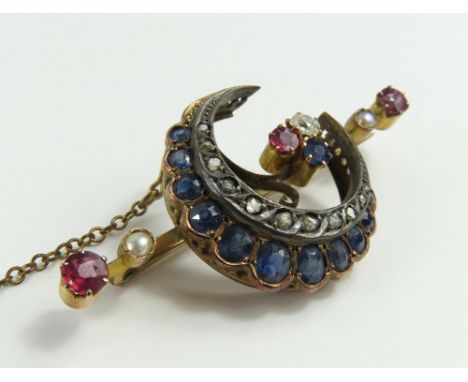 A Victorian sapphire, ruby, pearl, and diamond crescent brooch, the crescent set with sapphires and rose cut diamonds, the cr