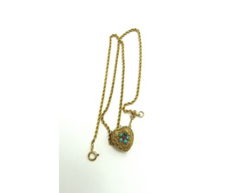 A heart shaped locket set with turquoise and a ruby amongst cannetille work, unusually hinged to the top, 1.6cm long, on a ro