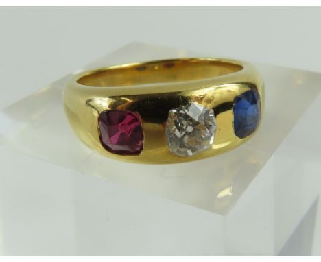 An unusual late Victorian diamond, sapphire and ruby gypsy three stone ring, the old cut diamond with a single square cut sap