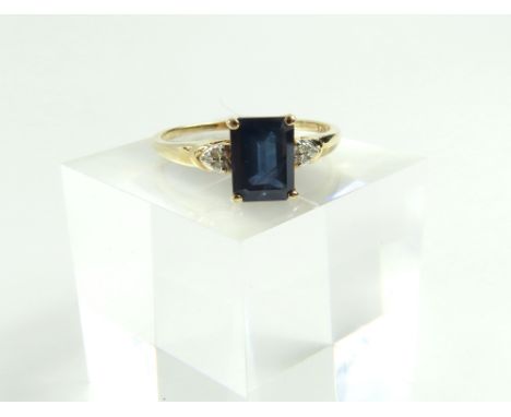 A 9ct gold sapphire and diamond dress ring, the step cut sapphire in a four claw setting, 1.9ct; with a trio of small diamond