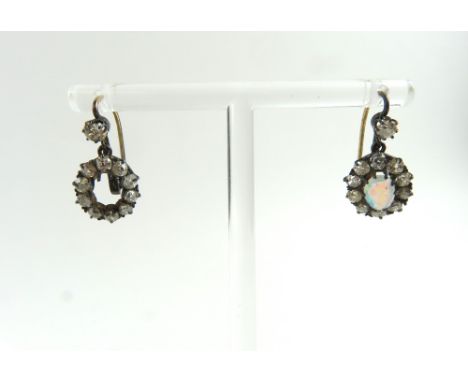 A pair of Victorian diamond and opal drop earrings, with a cluster of old cut diamonds around the opal, with a single diamond