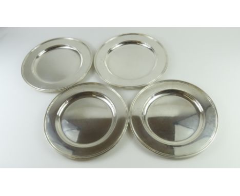Four Danish silver platters of modest form, with some ring embossments at the rim. Made by Carl M. Cohr with assay master's m