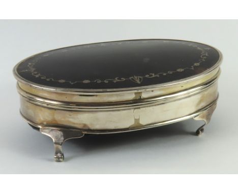 A silver and tortoise-shell box, oval shaped with four cabriole legs; the interior cushioned with purple velvet, possibly by 