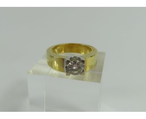 A chunky two colour gold diamond set ring, the round brilliant cut diamond in a heavy four claw setting, approximately 1.03ct