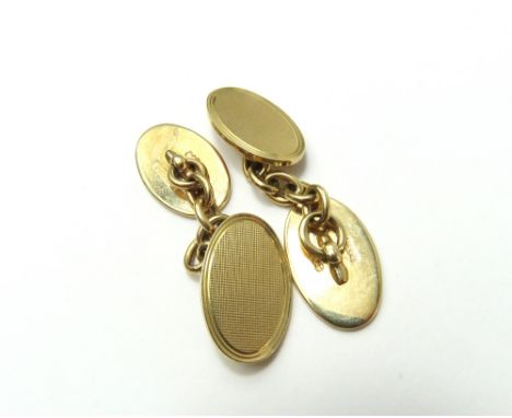 A pair of 9ct gold cufflinks, with two oval panels, one engraved with the initial S and the other engine turned, with chain l