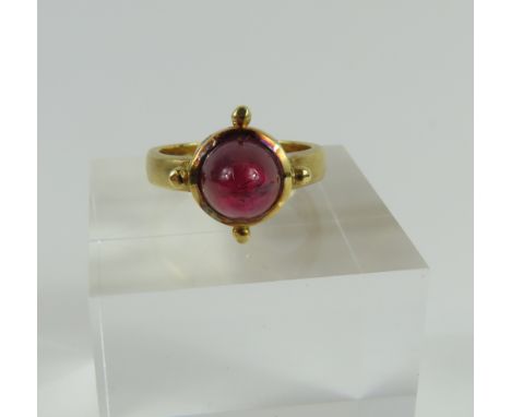 An 18ct gold contemporary design ring, by Orton, Bradford-on-Avon, the high cut cabochon cut pink tourmaline in a collet sett