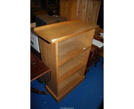 A floor standing Bookshelf in light oak, 29" wide x 11 1/2" deep x 42 1/2" high.