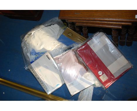 A quantity of new bed linen and curtains.