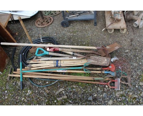 Large quantity of garden tools including forks, rakes, sledge hammer, etc.