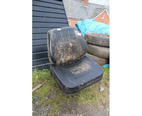 A Tractor seat with suspension, appears little used (cushions require reattachment).