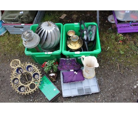 Two boxes containing oil lamp bases, candle holder, stainless steel chimney cowl, etc.