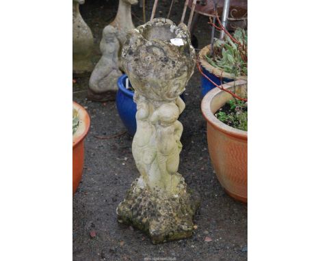 A concrete planter  having three cherubs to the base. 26" high.