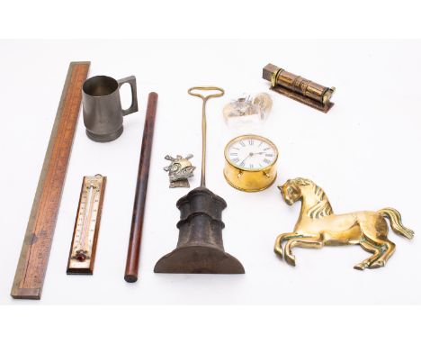 A group of miscellaneous collectables, including a thermometer, ruler, clock, desk calendar, brass horse emblem (from steam e