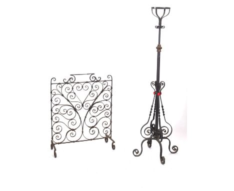A Victorian wrought iron standard lamp, circa 1900; the cresset basket (for an oil reservoir, now lacking) on a telescopic sh