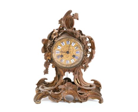 A Rococo revival gilt-metal mantel clock the eight-day duration movement striking the hours and half-hours on a bell with an 