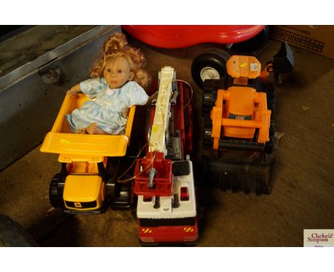 A child's fire engine; child's JCB digger and a child's truck and doll