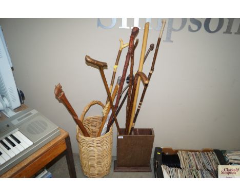 Two stick stands and contents of various walking sticks