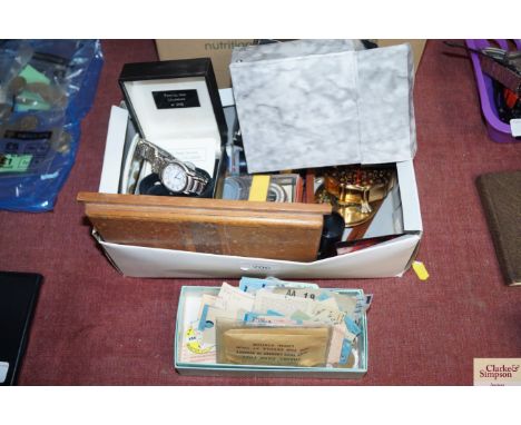 Two boxes containing various coinage, ticket stubs, wristwatches, nutcrackers etc