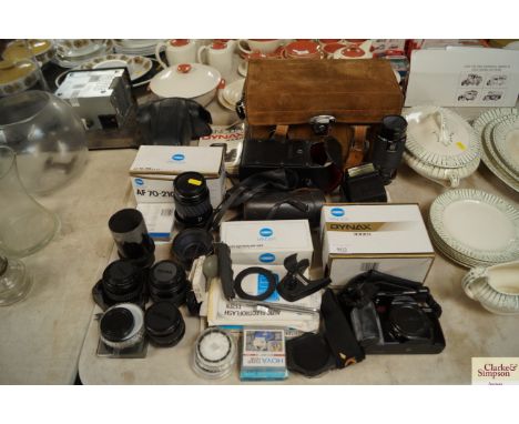 A collection of camera equipment including Minolta camera; various lenses and accessories