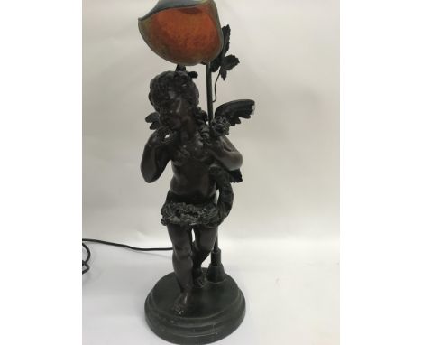 A side lamp in the Victorian style in the form o f a cherub with glass shade .