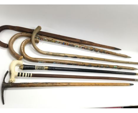 Collection of seven vintage walking sticks and canes including a pic-nic-stick. Alpine hiking sticks covered in early/mid 20t
