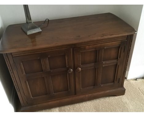 An Ercol cabinet with hinged top. Sizes 41wide - 19 1/2 deep - 28 high (approx)