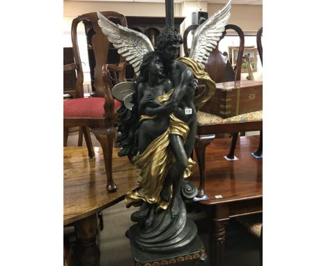 A large composition classical type lamp with winged figures on a stylised base.