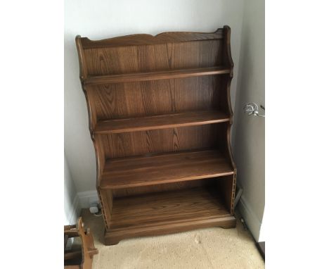 An Ercol 3 shelve bookcase with cupboard. Sizes in inches - 33wide - 13 deep - 50 high (approx)