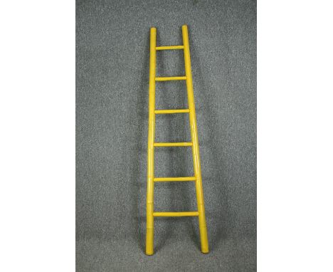 A yellow painted bamboo ladder. H.197cm. 