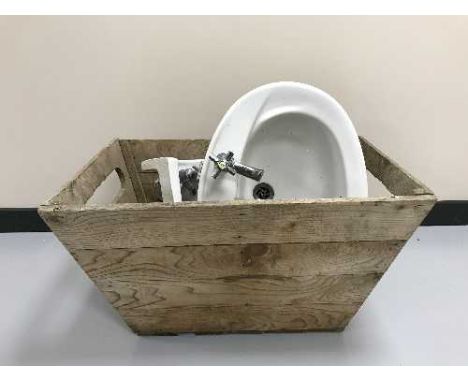 A pine box containing two ceramic basins 