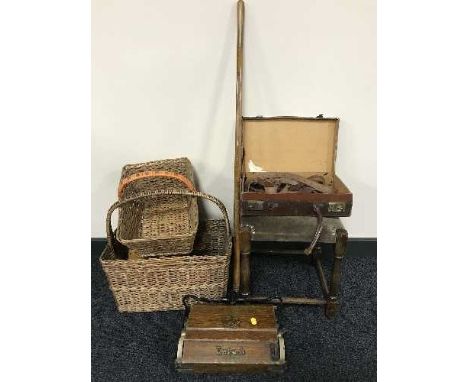 An early 20th century oak stool, small leather briefcase, wicker baskets, vintage floor cleaner