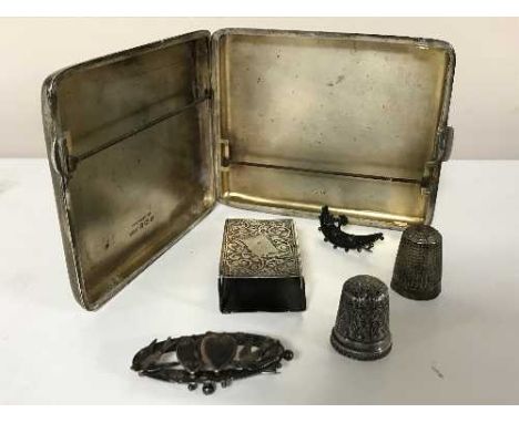 A group of silver to include cigarette case, matchbox holder, two thimbles, two Victorian brooches