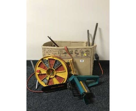 A box containing Black and Decker chain saw, hand tools, bench vice etc