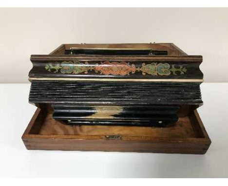 An accordion in pine box
