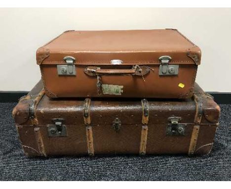 A vintage canvas bound luggage case and a leather suitcase 