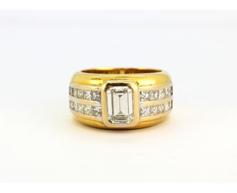 A gentleman's 18ct yellow gold (stamped 750) ring set with an emerald cut diamond and princess cut diamond set shoulders, app