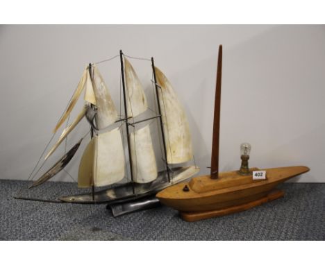 An Art Deco wooden yacht table lamp and a horn sailing ship.