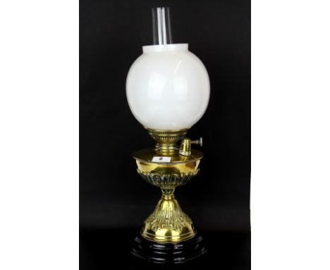 An early 19th century brass mounted oil lamp, H. 55cm.