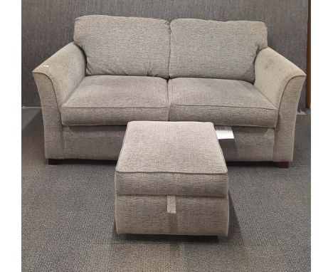 A contemporary grey fabric three seater sofa together with a storage compartment footstool.