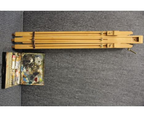 A vintage artists paint box and easel.