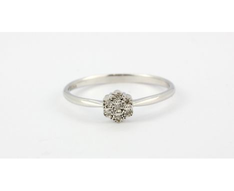 A 9ct white gold (stamped 375) cluster ring set with brilliant cut diamonds, (S).
