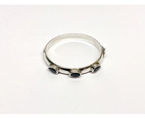 A 925 silver and blue topaz bangle.