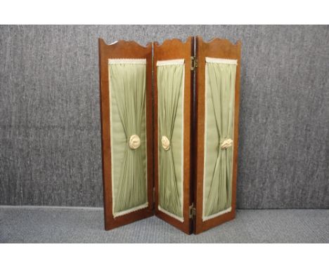 A double sided three panel folding screen, H. 81cm.