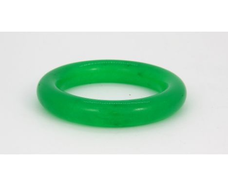 A jade / hardstone bangle, Dia. 9cm.