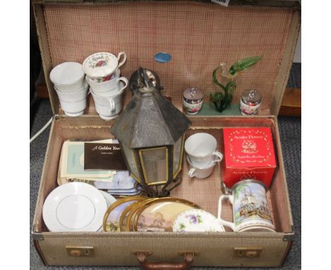 A vintage suitcase of ceramic and other items.