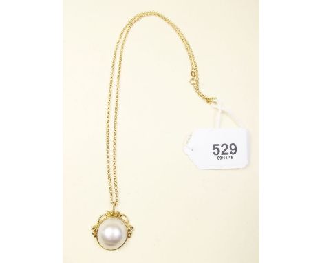 An 18 carat gold baroque pearl pendant on 9 carat gold chain