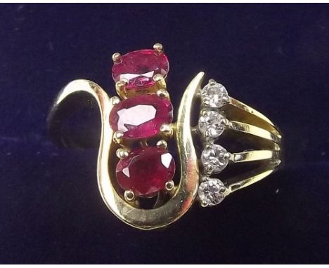 A 14 carat gold asymetrical ruby and diamond ring - size 0