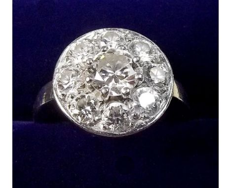 A platinum set diamond cluster ring with eight stone surround