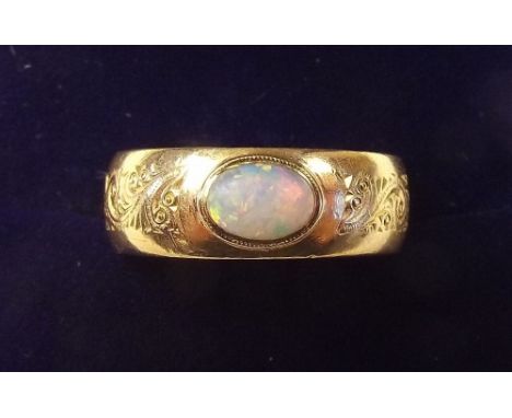 A 22 carat gold ring with engraved decoration and set opal - size L