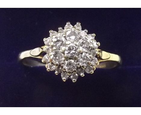 A gold and diamond set cluster ring - size S